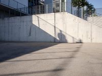 an empty parking lot with an outside stair way that leads to the bottom level and below a ramp