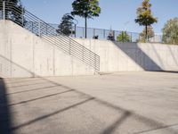 an empty parking lot with an outside stair way that leads to the bottom level and below a ramp
