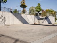 an empty parking lot with an outside stair way that leads to the bottom level and below a ramp
