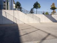 an empty parking lot with an outside stair way that leads to the bottom level and below a ramp
