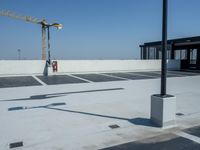 a street light is attached to a post in the parking lot outside a construction site