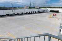 a parking lot is empty of cars and a no parking sign on the railing in front