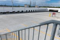 a parking lot is empty of cars and a no parking sign on the railing in front