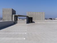 a empty parking lot with a parking space in the middle of it and a sky background