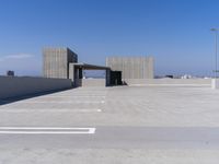 a empty parking lot with a parking space in the middle of it and a sky background