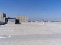 a empty parking lot with a parking space in the middle of it and a sky background