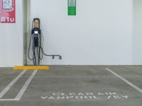 an electric car charging station is located in a building with the words clean air and vandalized