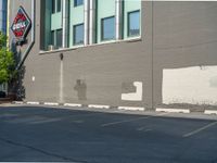 a paved street has been painted light gray, with gray brick walls and concrete edges