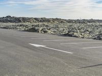 a large area of dirt with signs marked in it in front of a blue sky