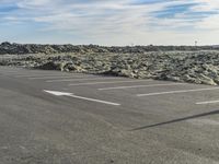 a large area of dirt with signs marked in it in front of a blue sky