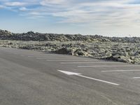 a large area of dirt with signs marked in it in front of a blue sky