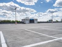 a parking lot with a store front and parking spaces in it on a partly cloudy day