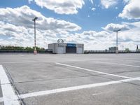 a parking lot with a store front and parking spaces in it on a partly cloudy day