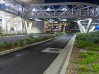 a view of a road and an overpass with traffic passing through it by buildings