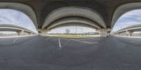 there is an upside down shot of a parking lot underneath a large overpass bridge