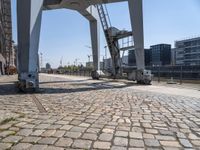 a parking meter sits outside of a building on an overpassed area with a metal structure