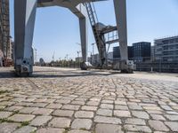 a parking meter sits outside of a building on an overpassed area with a metal structure