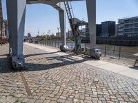 a parking meter sits outside of a building on an overpassed area with a metal structure