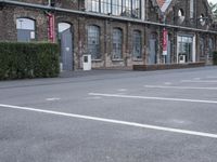 several parking spaces are set up outside a building for public use, with no parking sign posts on them