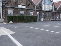 several parking spaces are set up outside a building for public use, with no parking sign posts on them