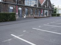 several parking spaces are set up outside a building for public use, with no parking sign posts on them