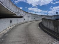 there are many parking spaces located on this street bridge of a tunnel under the highway