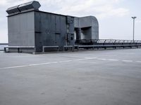 a boat is parked in an empty parking lot near an air port on the water