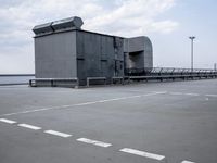 a boat is parked in an empty parking lot near an air port on the water