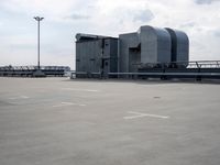 a boat is parked in an empty parking lot near an air port on the water