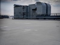 a boat is parked in an empty parking lot near an air port on the water