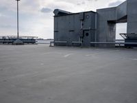 a boat is parked in an empty parking lot near an air port on the water