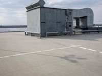 a boat is parked in an empty parking lot near an air port on the water