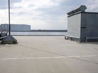 a boat is parked in an empty parking lot near an air port on the water
