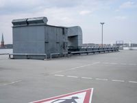 a boat is parked in an empty parking lot near an air port on the water