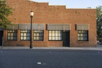 the building has several windows on it and a lamp pole in front of it,