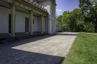 a very long paved sidewalk on a big nice day outside the mansion area at home