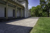 a very long paved sidewalk on a big nice day outside the mansion area at home