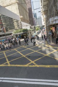 people are crossing the street at an intersection with a tram going down it's side
