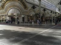 people standing around in a mall with an open floor plan to sit, walk, and watch a display