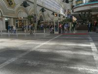 people standing around in a mall with an open floor plan to sit, walk, and watch a display