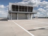 two people walk across the tarmac of an airplane hangar on a cloudy day in flight