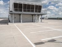 two people walk across the tarmac of an airplane hangar on a cloudy day in flight