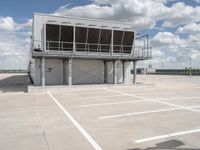 two people walk across the tarmac of an airplane hangar on a cloudy day in flight