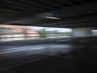 an empty parking lot with a white and red motorcycle parked next to it, and people walking by in the background