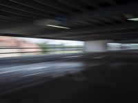 an empty parking lot with a white and red motorcycle parked next to it, and people walking by in the background
