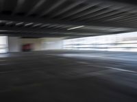 an empty parking lot with a white and red motorcycle parked next to it, and people walking by in the background