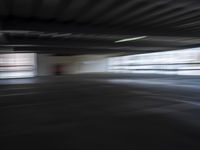an empty parking lot with a white and red motorcycle parked next to it, and people walking by in the background