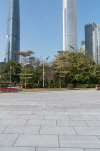 a group of people are walking around in the city on a sunny day with skyscrapers in the background