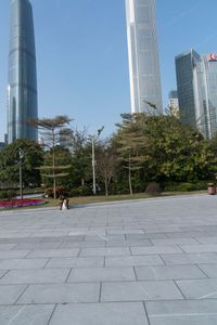 a group of people are walking around in the city on a sunny day with skyscrapers in the background