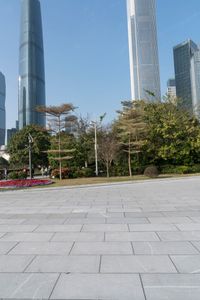 a group of people are walking around in the city on a sunny day with skyscrapers in the background